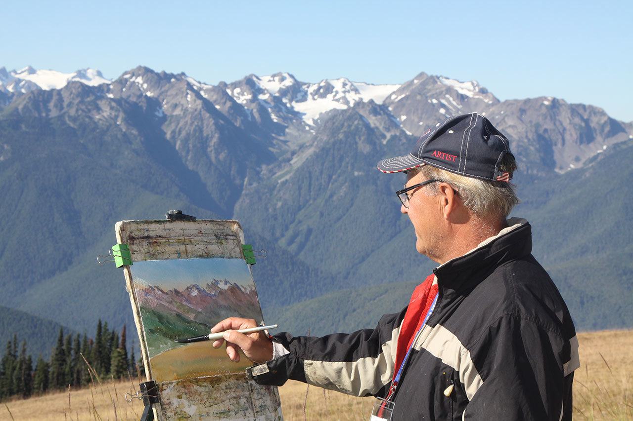 Bill Rogers of Nova Scotia, Canada, paints a watercolor of the Olympics from Hurricane Ridge Visitor Center on Wednesday. In celebration of the National Park Service centennial, artists are painting as part of the Paint the Peninsula competition. (Dave Logan/for Peninsula Daily News)