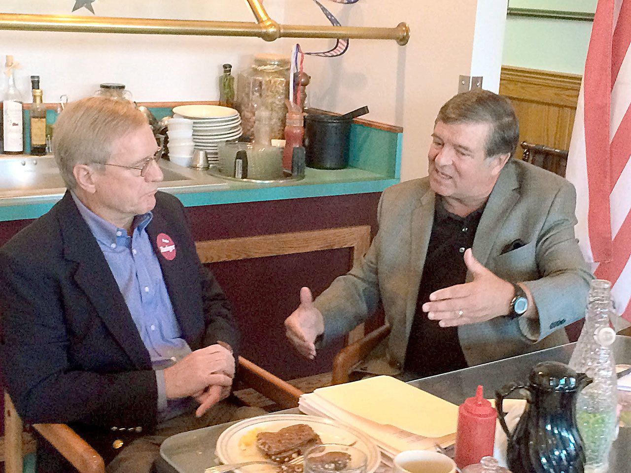 Steve Tharinger of Sequim, left, incumbent 24th District state representative, and John Alger of Sequim, who is challenging Tharinger for the position, chat Tuesday after a candidates forum. (Paul Gottlieb/Peninsula Daily News)