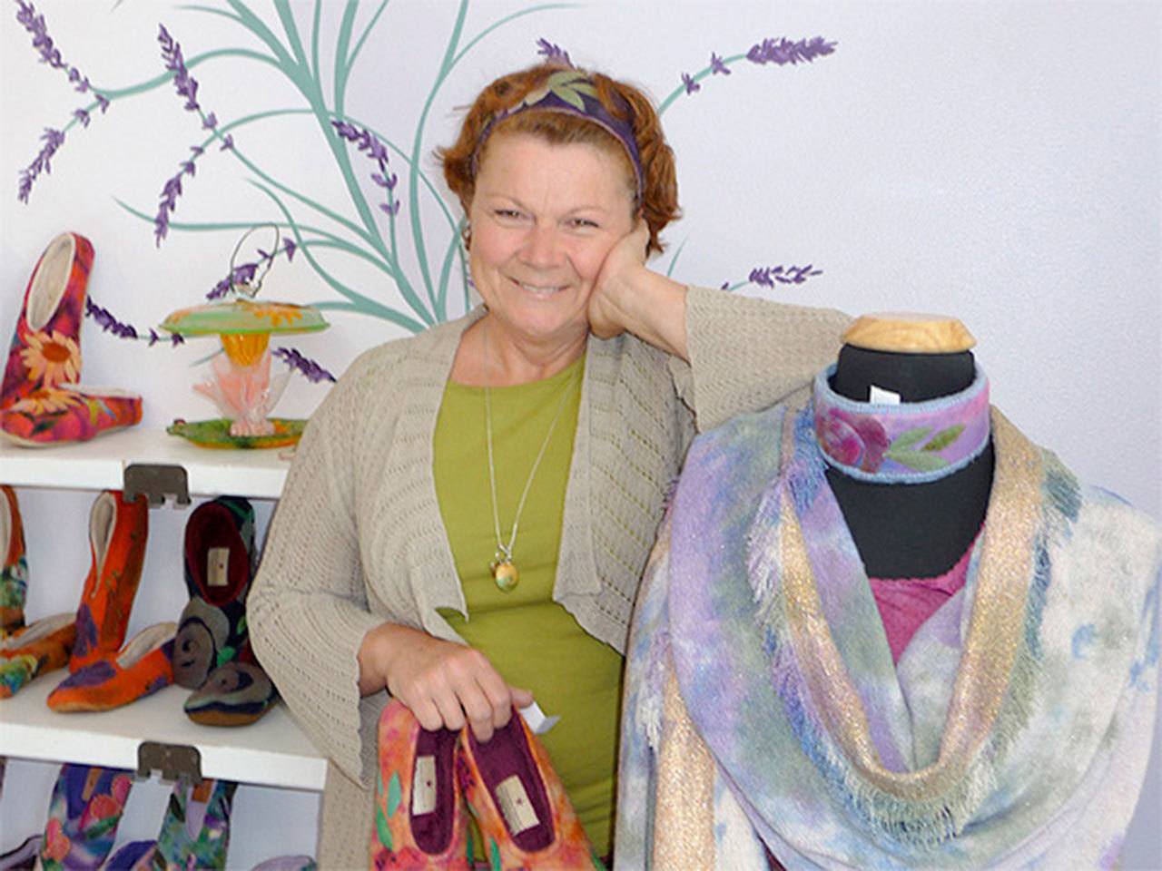 Victoria Julian-Gray is seen with slippers and headbands made of appliquéd felt and handcrafted shawls in her new shop in downtown Sequim. (Patricia Morrison Coate/Olympic Peninsula News Group)
