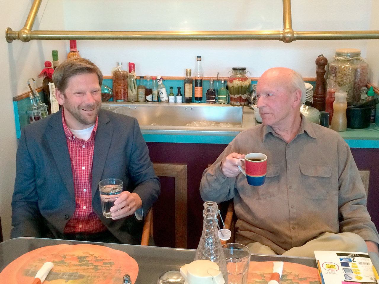 Candidates Mike Chapman, left, and George Vrable chat Tuesday morning before answering questions at a 24th Legislative District election forum. (Paul Gottlieb/Peninsula Daily News)
