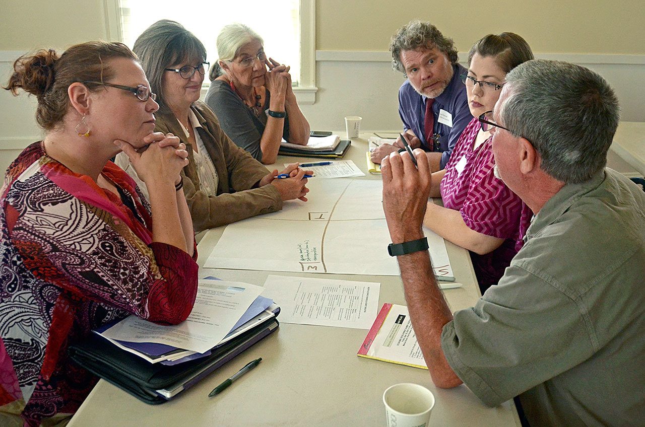 Brad Taylor of Port Townsend schools, right, speaks to, from left, Magdalene Adenau of the Jefferson County Young Professionals Network, Port Townsend Mayor Deb Stinson, Judith Morris of U.S. Rep. Derek Kilmer’s office, Joel Peterson of the Jefferson County Department of Community Development and Jill teVelde of Peninsula College. (Cydney McFarland/Peninsula Daily News)