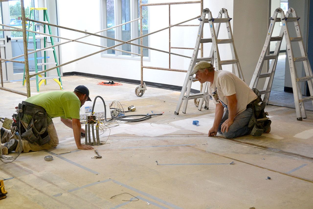 Joe Kessler, left, and Joel Herb, co-owner of Moon Construction Specialities, work on constructing the front desk area of the YMCA of Sequim on September 20th. YMCA officials plan to hold a soft opening for the Sequim facility on Oct. 24 and be fully operational by Nov. 1. (Matthew Nash/Olympic Peninsula News Group)