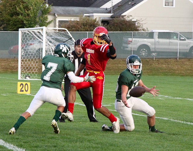 Dave Logan/for Peninsula Daily News Port Angeles’ Easton Joslin, right, nearly intercepts a pass intended for Mount Tahoma’s Ira Branch (1), as Roughriders’ teammate Rudy Valdez watches during a game last month.