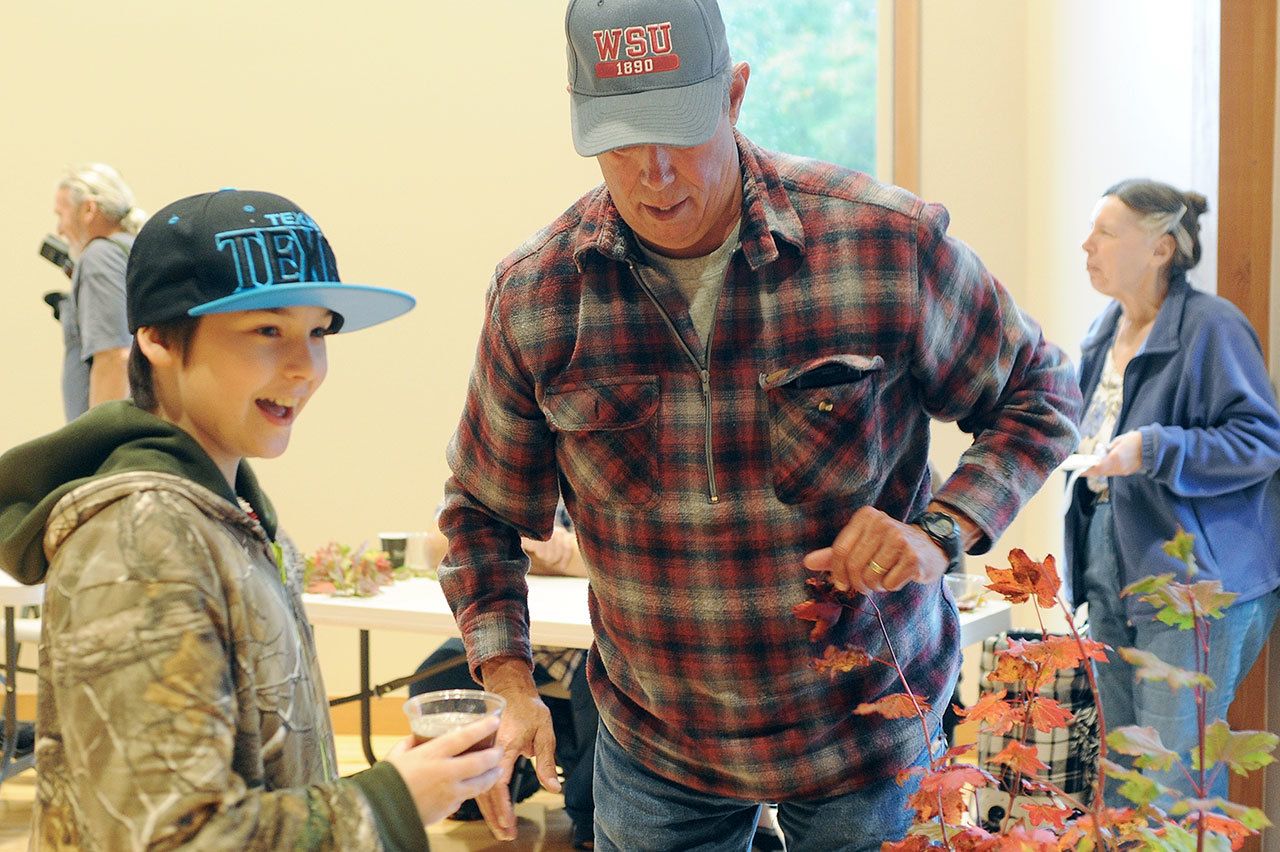 Lonnie Archibald/for Peninsula Daily News Sean Thornhill drinks Gordon Gibbs’, right, Root Beer during last years Fish and Brew held at the RAC.