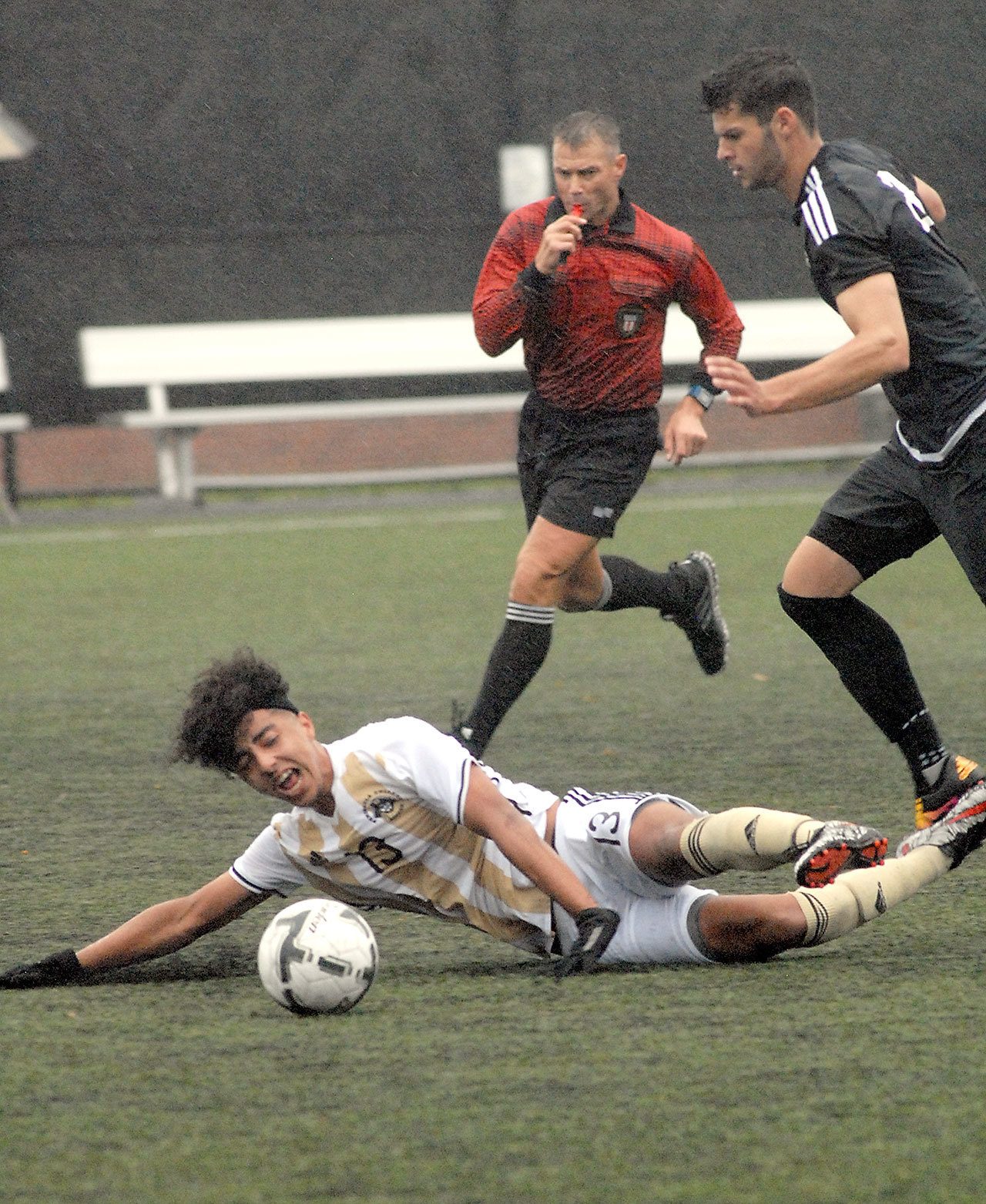 Keith Thorpe/Peninsula Daily News Peninsula’s Joey Hollimon hits the turf after getting tangled up with Tacoma’s Tanner Allison in the first half of their NWAC playoffmatch on Saturday at Wally Sigmar Field in Port Angeles.