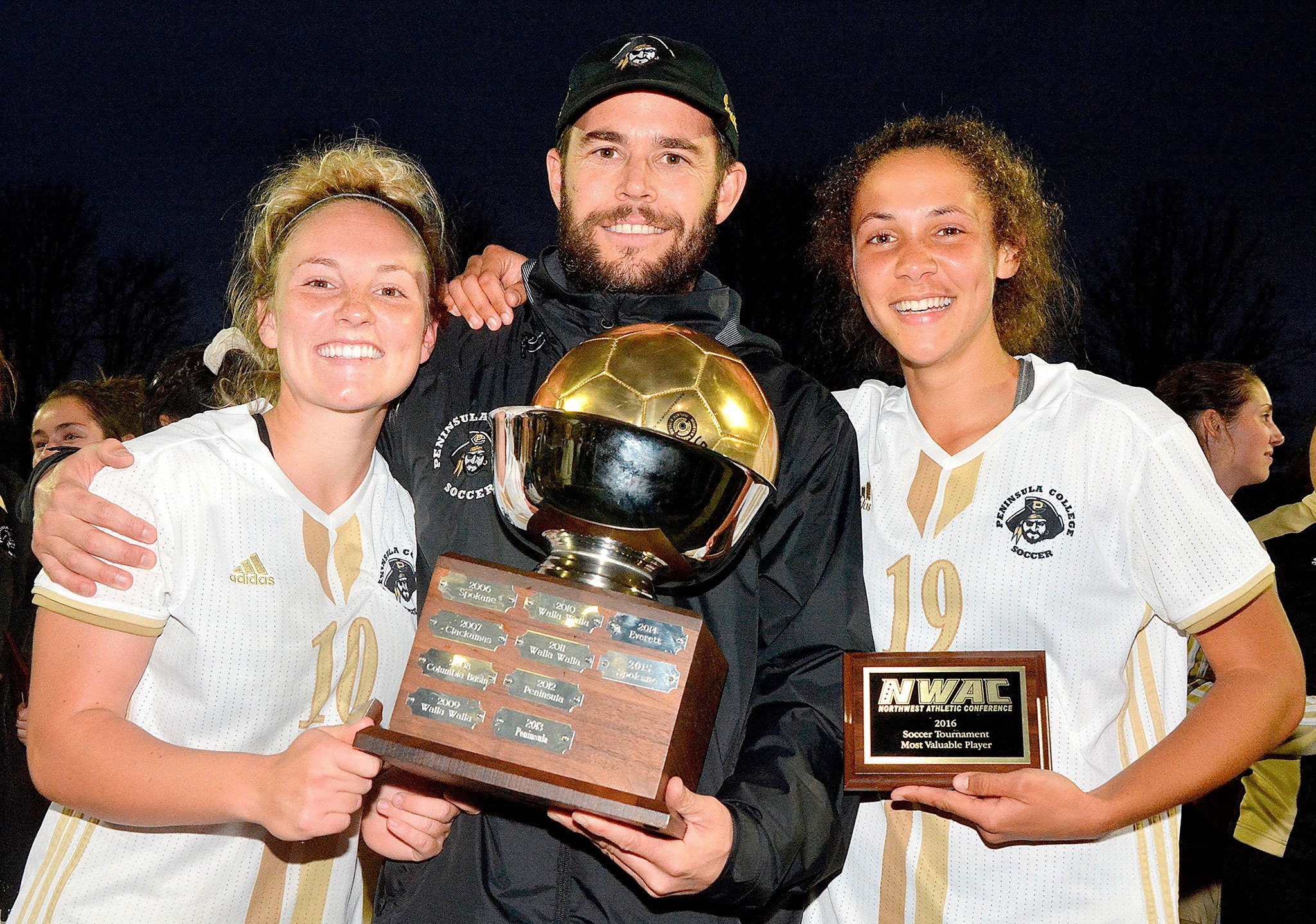 Peninsula College photo Peninsula women’s soccer coach Kanyon Anderson celebrates the Pirates’ NWAC championship Nov. 13 in Tukwila with players Kennady Whitehead, left, and Bri Valiente.