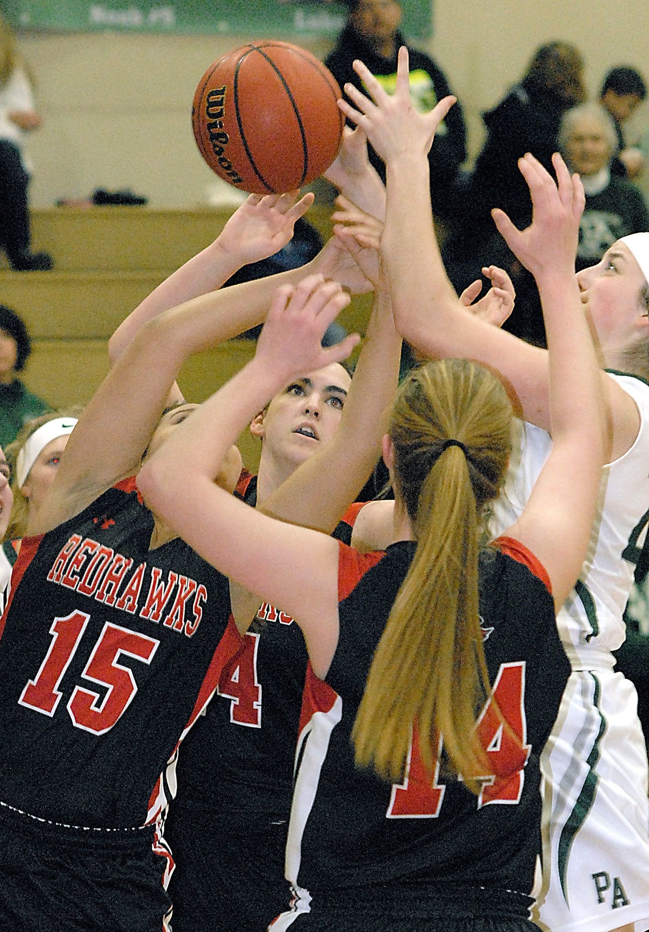 Keith Thorpe/Peninsula Daily News A free-for-all for a rebound takes the attention of Port Townsend players, from left, Jordyn King, Izzy Hammett and Jenna Carson, and Port Angeles’ Aeverie Politika, right, in the second quarter on Friday night at Port Angeles High School.