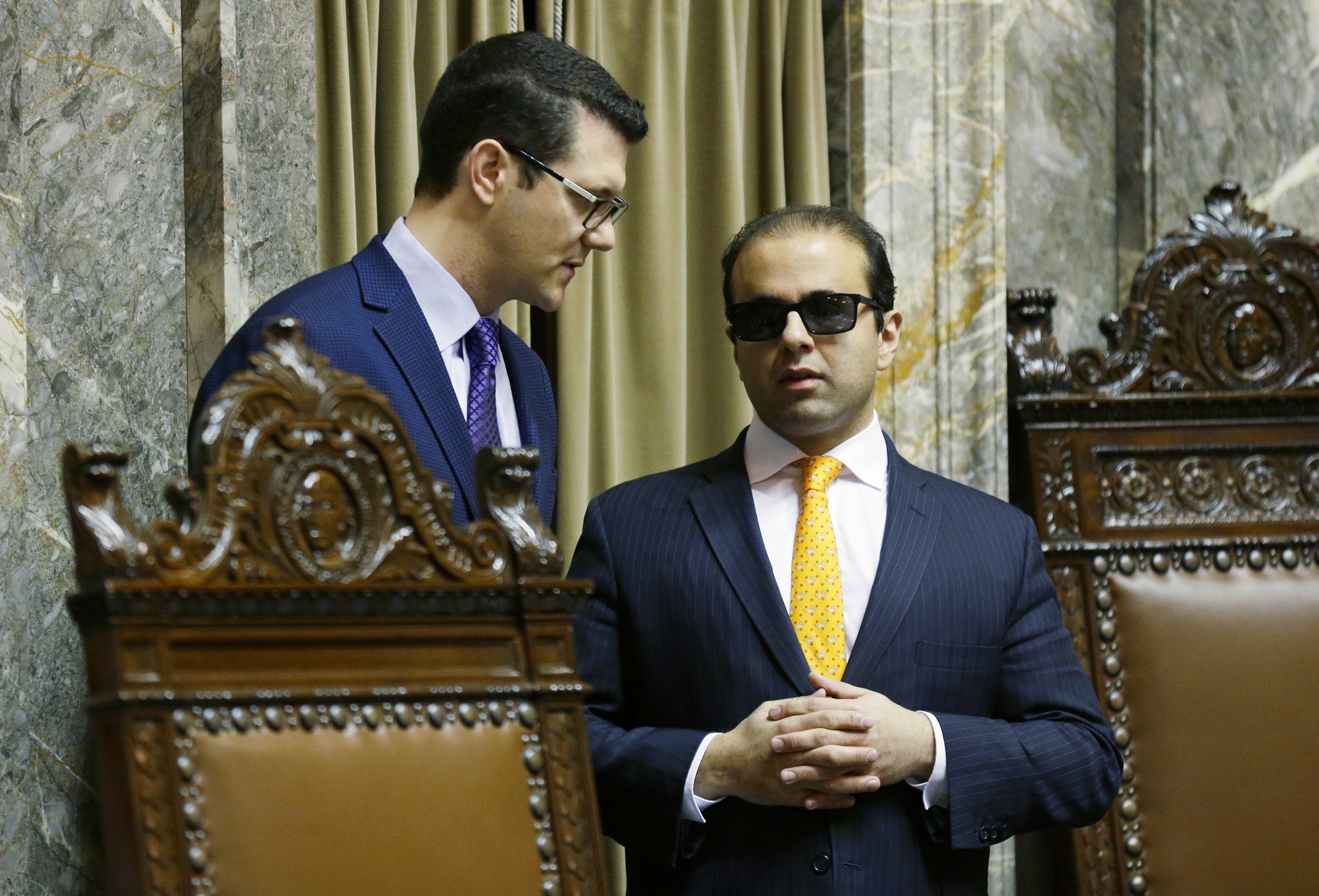 Senate Republican floor leader Joe Fain, R-Auburn, left, confers with Lt. Gov. Syrus Habib as Habib presides over the Senate on Friday in Olympia. (Ted S. Warren/The Associated Press)
