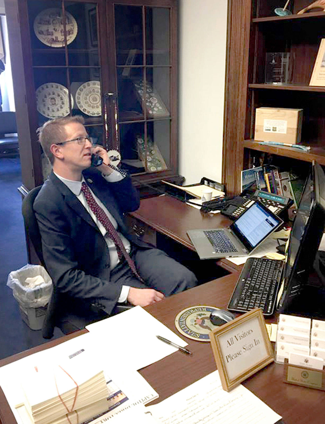 U.S. Rep. Derek Kilmer speaks with a constituent before heading to the floor to vote against the health care bill Friday in Washington, D.C.