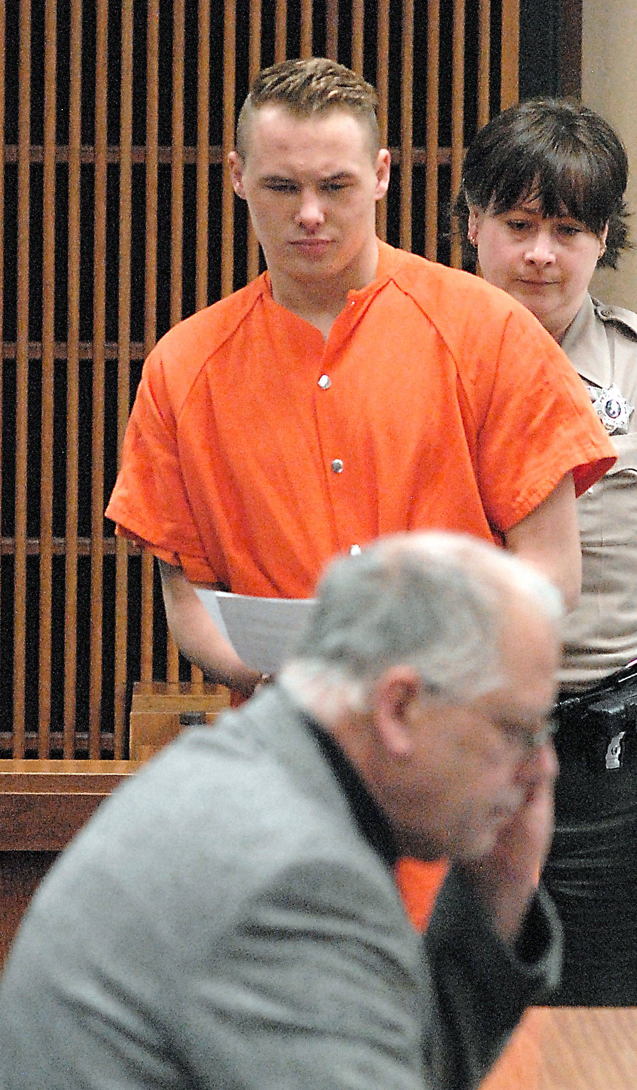 Benjamin Bonner approaches defense attorney Harry Gasnick during Bonner’s first appearance in Clallam County Superior Court last month. (Keith Thorpe/Peninsula Daily News)