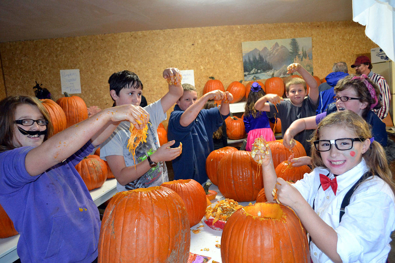 Children celebrate at the Pumpkin Party in the Sequim Prairie Grange’s outdoor kitchen a few years ago. The event grew from an effort to start a Junior Grange in the area and has continued for 12 years each October. Sequim Gazette file photo by Matthew Nash