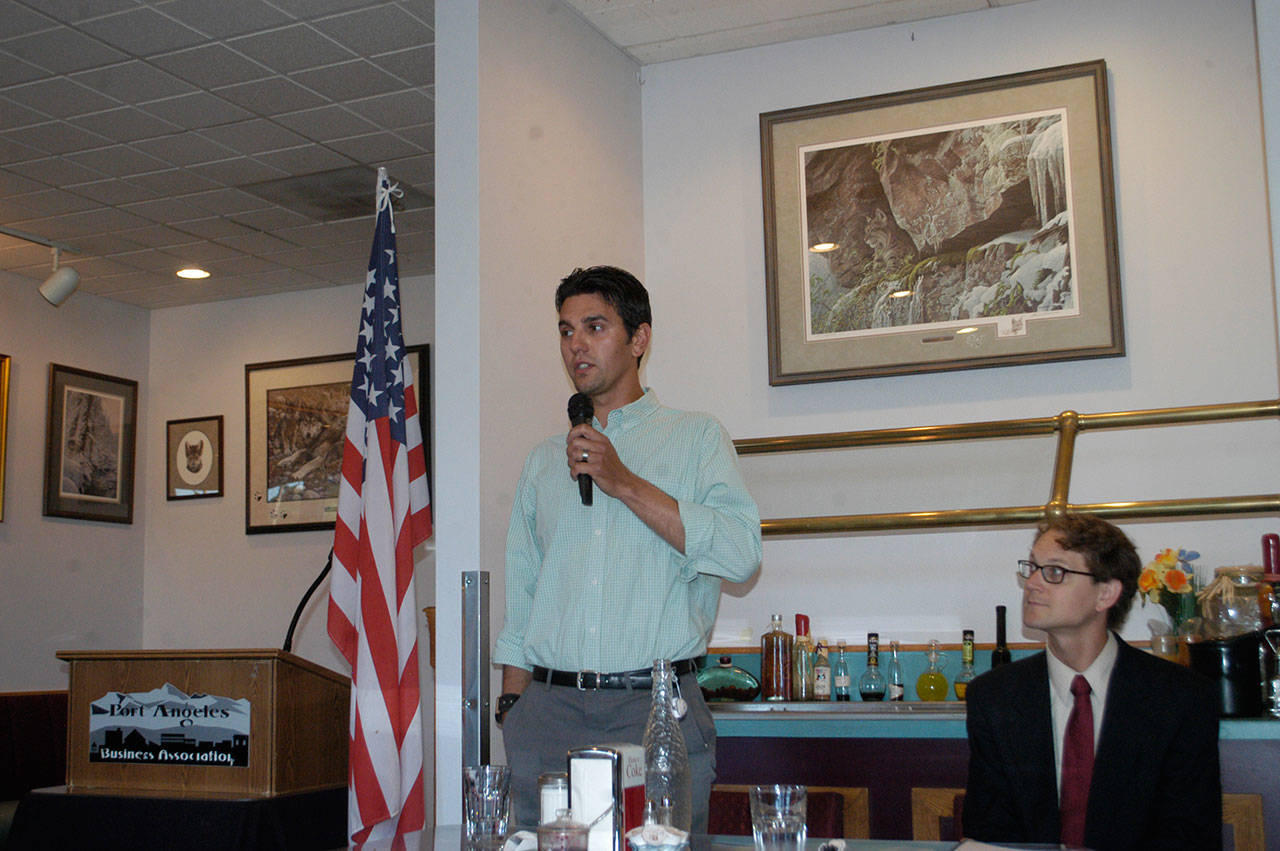 Artur Wojnowski speaks at a Port Angeles Business Association candidate forum at Joshua’s Restaurant on Tuesday as his opponent, Lindsey Schromen-Wawrin, looks on. Wojnowski and Schromen-Wawrin are running for Port Angeles City Council. (Rob Ollikainen/Peninsula Daily News)