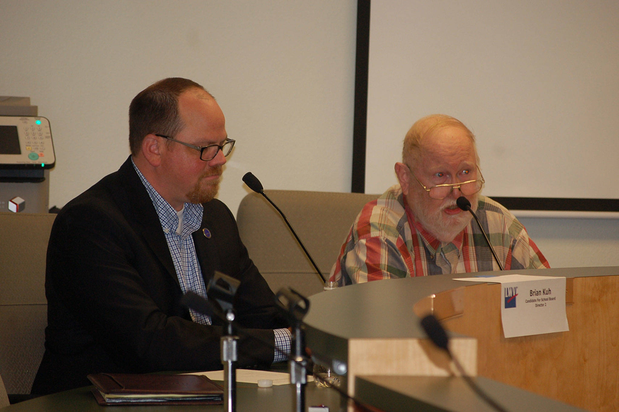 Sequim School District Board of Directors candidate Brian Kuh listens as his opponent Jon Kirshbaum speaks at a League of Women Voters forum last Thursday. (Erin Hawkins/Olympic Peninsula News Group)