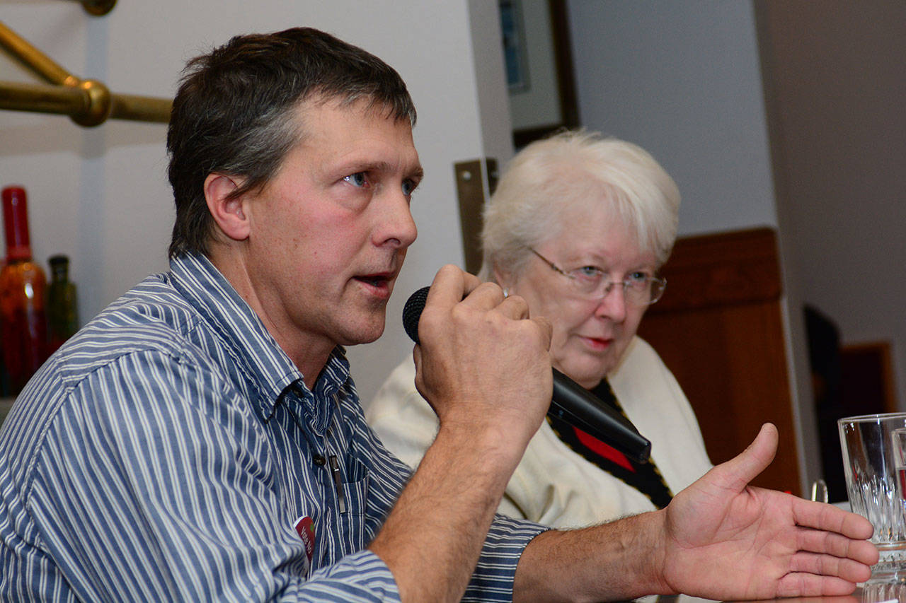 David Mabrey of Port Angeles and Edna Willadsen debated the proposition for Port Angeles to change to a second-class city during a Port Angeles Business Association forum Tuesday. (Jesse Major/Peninsula Daily News)