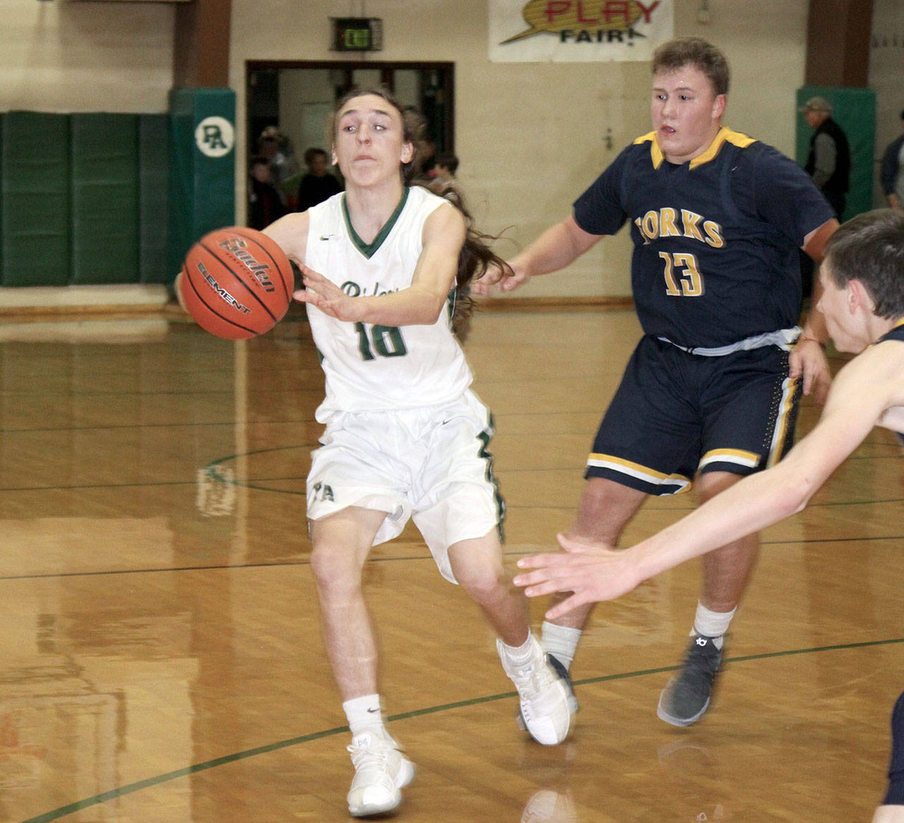 Port Angeles’ Gary Johnson passes off during the Port Angeles High School Jamboree Monday night. Pressuring on defense is Forks’ Cort Prose (13). Port Angeles won this game 24-16 as the jaboree also featured teams from Port Townsend and Chimacum. Prep basketball season is now underway as the Port Angeles boys played their first game of the year Tuesday against Bainbridge, while the Roughrider girls open up their season at 7 p.m. Wednesday with a home game against Bainbridge. (Dave Logan/for Peninsula Daily News)