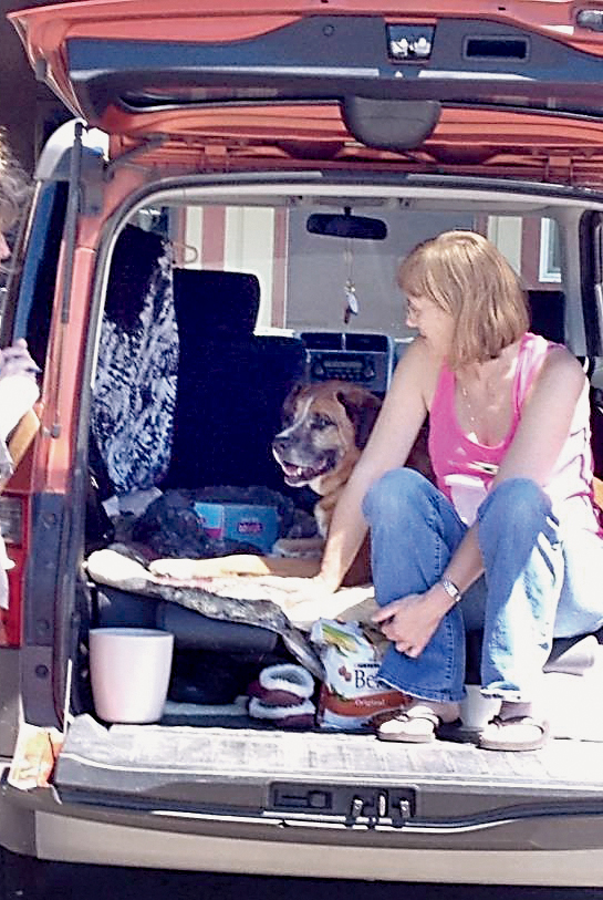 Joni Evans sits with her dog