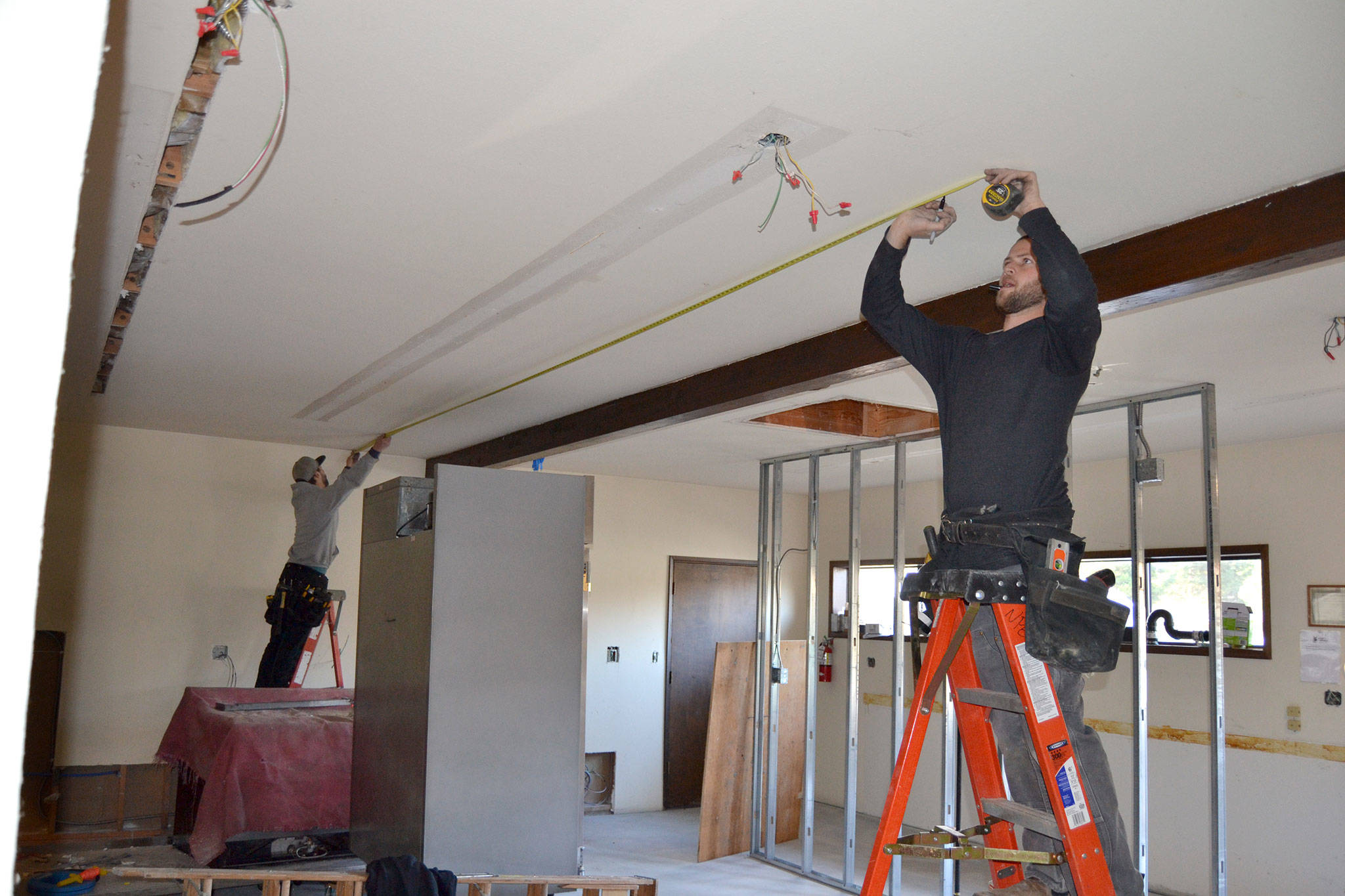 &lt;strong&gt;Matthew Nash&lt;/strong&gt;/Olympic Peninsula News Group                                Tyler Philp, left, and Tyler Wickersham with North Peninsula Electric take measurements for new lighting inside the Guy Cole Convention Center’s commercial kitchen.