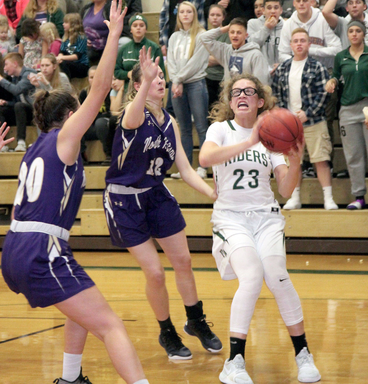 <strong>Dave Logan</strong>/for Peninsula Daily News Port Angeles’ Madison Cooke (23) pulls up for a shot while guarded by North Kitsap’s Erin Pearson, left, and Grace Johnson.