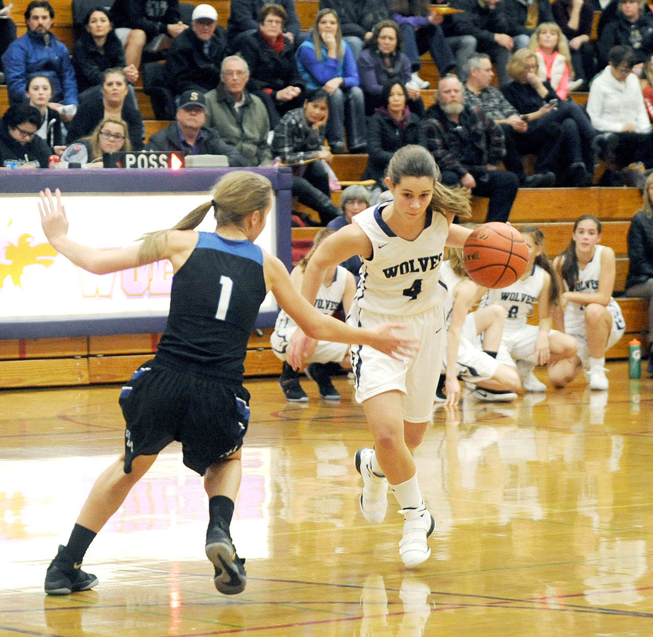 Pilar Aliseda, a Spanish exchange student on the Sequim varsity, drives against North Mason’s Natalie Carstensen during a game in December. (Michael Dashiell/Olympic Peninsula News Group)