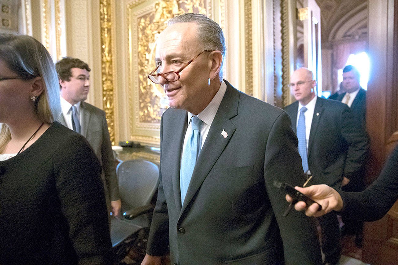 Senate Minority Leader Chuck Schumer, D-N.Y., heads to the chamber with fellow Democrats for a procedural vote aimed at reopening the government, at the Capitol in Washington, Monday, Jan. 22, 2018. (AP Photo/J. Scott Applewhite)