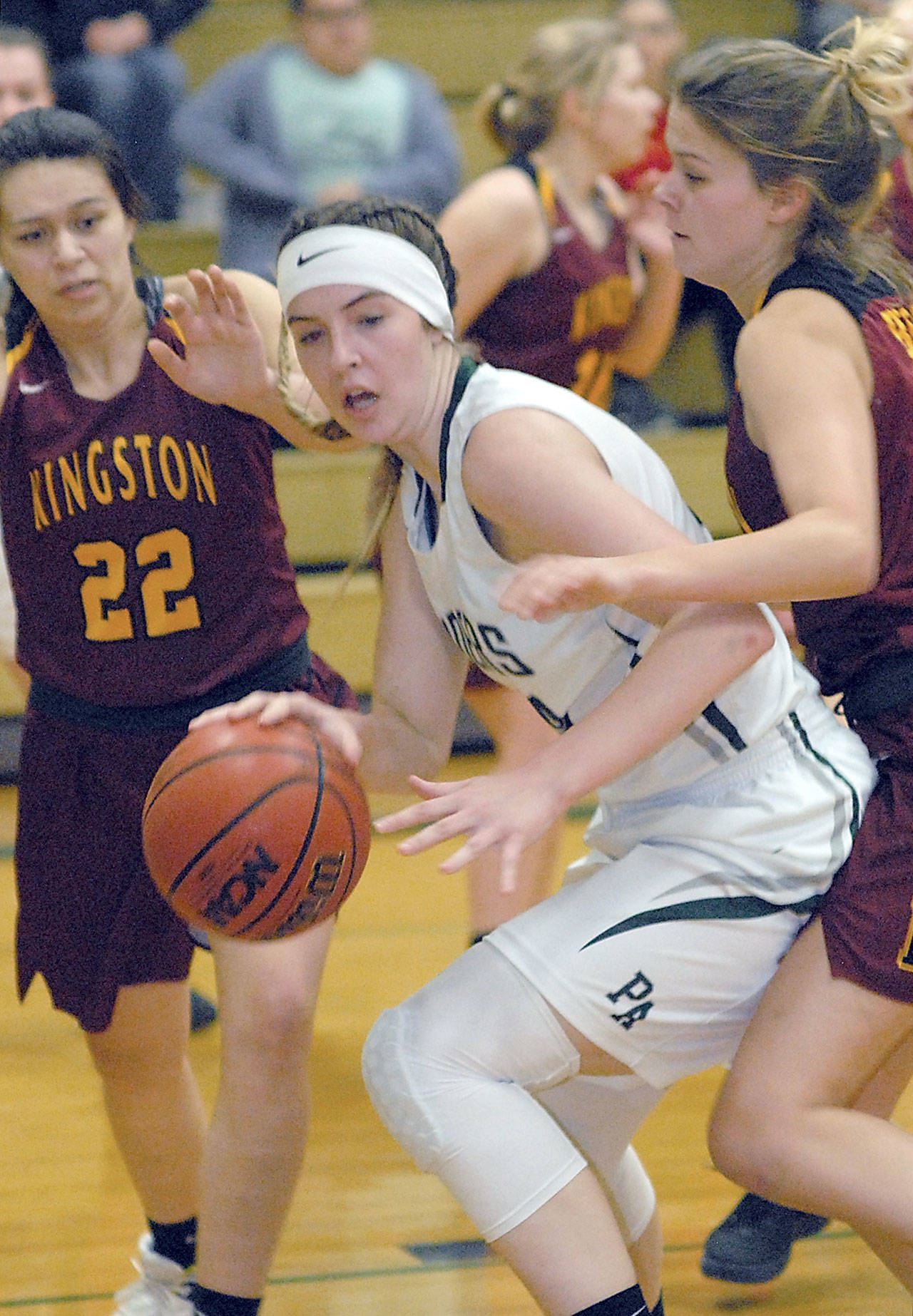 Keith Thorpe/Peninsula Daily News Port Angeles’ Devin Edwards, center, tries to escape the defense of Kingston’s Karliegh Gomez, left, and Avy Hiner during a game earlier this season.