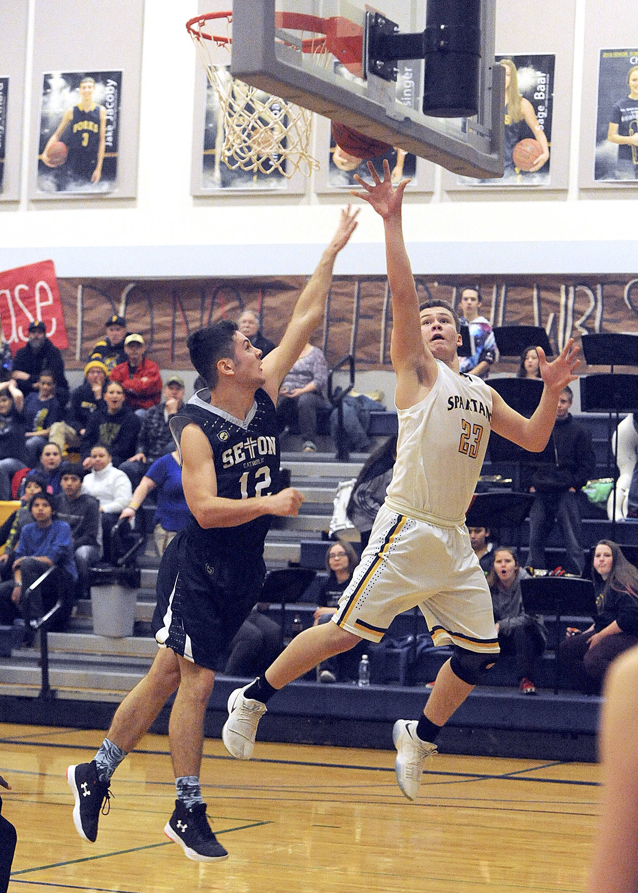 &lt;strong&gt;Lonnie Archibald&lt;/strong&gt;/for Peninsula Daily News                                Forks’ Braton Armas, right, scores around Seton Catholic’s Hayden Miller during the Spartans’ Southwest District 4 playoff game in Forks on Friday.