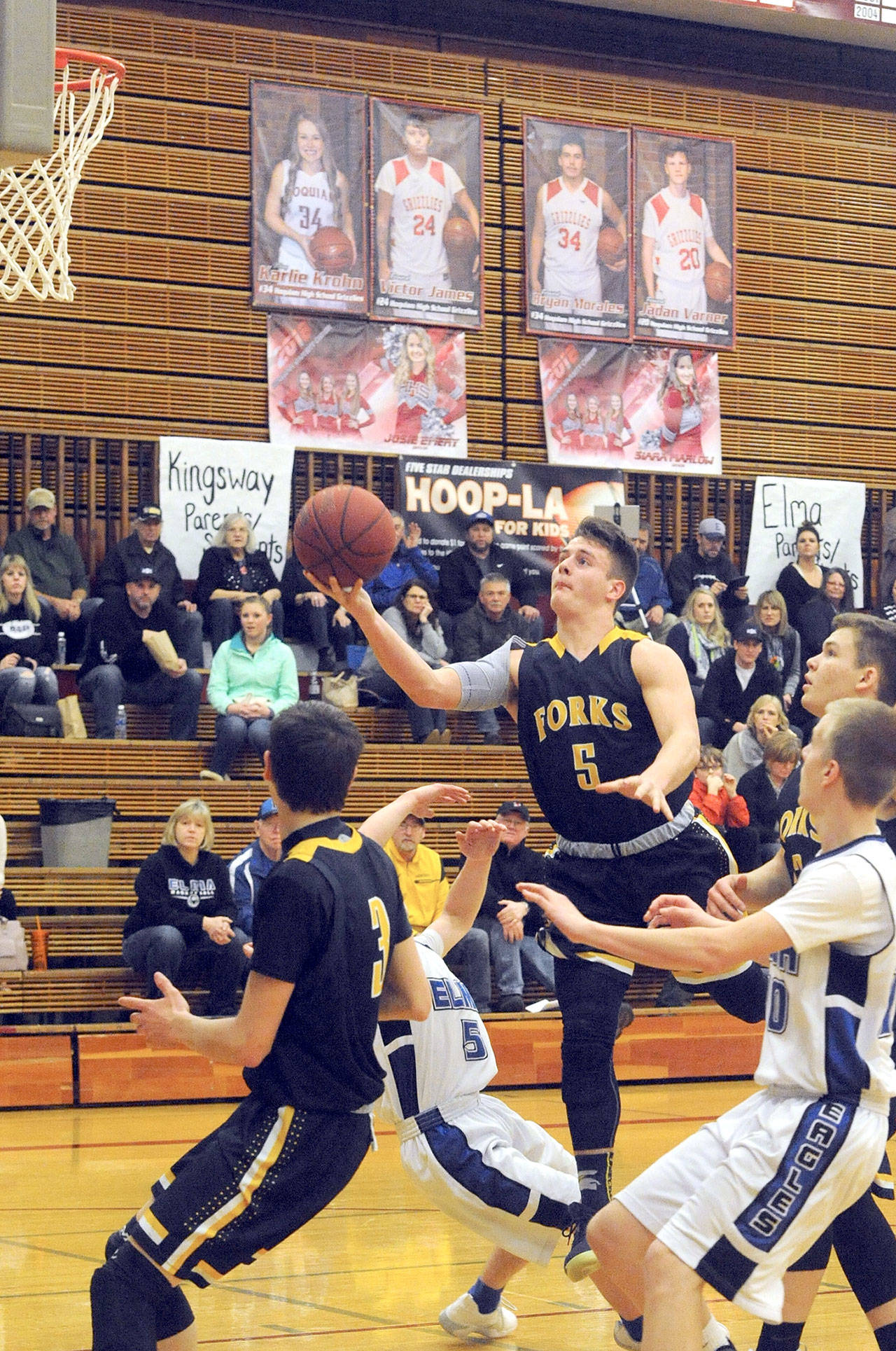 Forks’ Cole Baysinger (5) drives the lane and scores against Elma during the Spartans’ win onTuesday evening in Hoquiam. Lonnie Archibald /for Peninsula Daily News