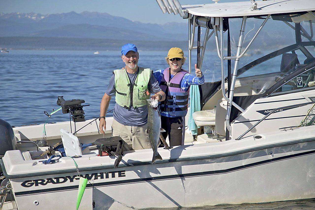 John Reed and Karen Overstreet, both of Seattle, show off a chinook caught while fishing at Midchannel Bank off Port Townsend in 2016.                                Steve Mullensky/for Peninsula Daily News