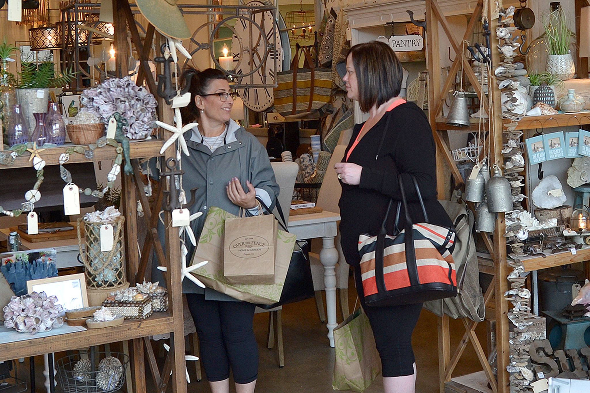 Friends Charlotte Schell and Kristine Trueman, both of Vancouver, B.C., shop in Field Notes Home & Garden & Gifts in Sequim. Trueman said she’s not surprised to learn about Sequim being nominated as one of the “Best Small Towns for Shopping” by USA Today. She’s been coming to Sequim for 20 years with her husband for a golf tournament and uses the opportunity to buy gifts for family and friends. (Matthew Nash/Olympic Peninsula News Group)