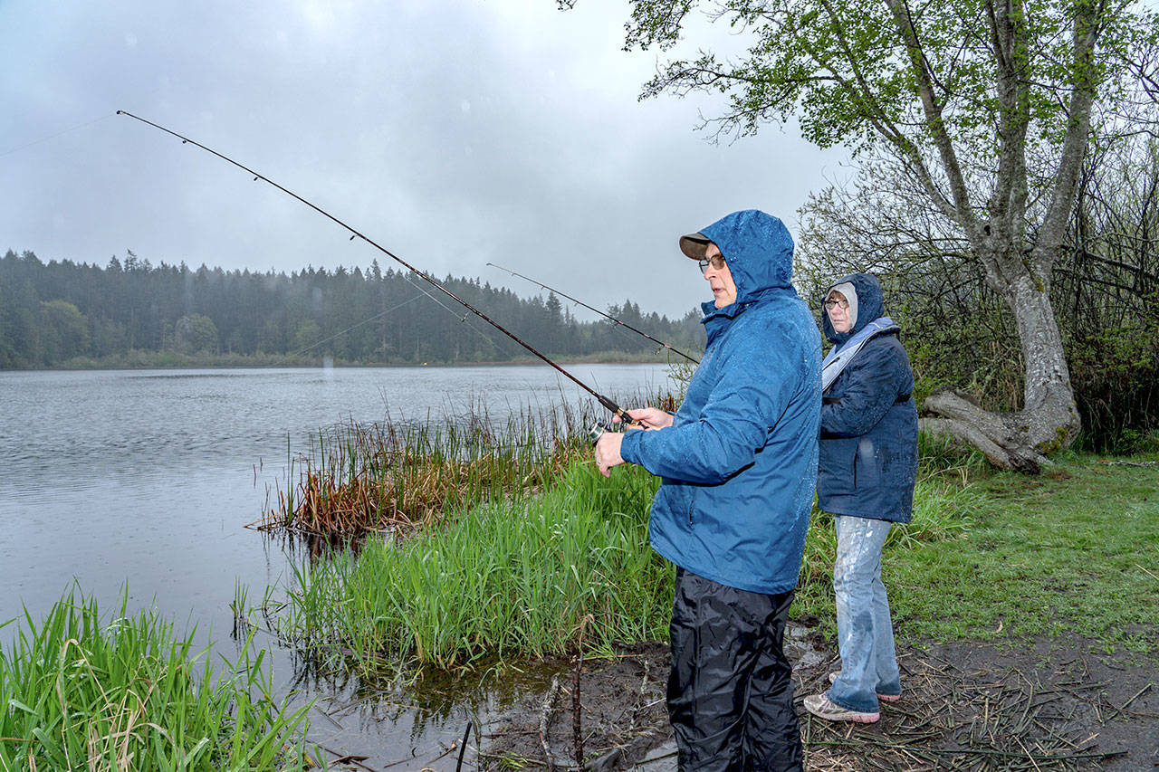 Steve Mullensky/for Peninsula Daily News Brian and Karin Kirkwood, from Kingston, have Anderson Lake practically all to themselves on the opening of trout season on Saturday. The Kirkwoods have been coming to Anderson for 8 years because they catch and release and the fish are hooked on the lip and are easier to de-hook.