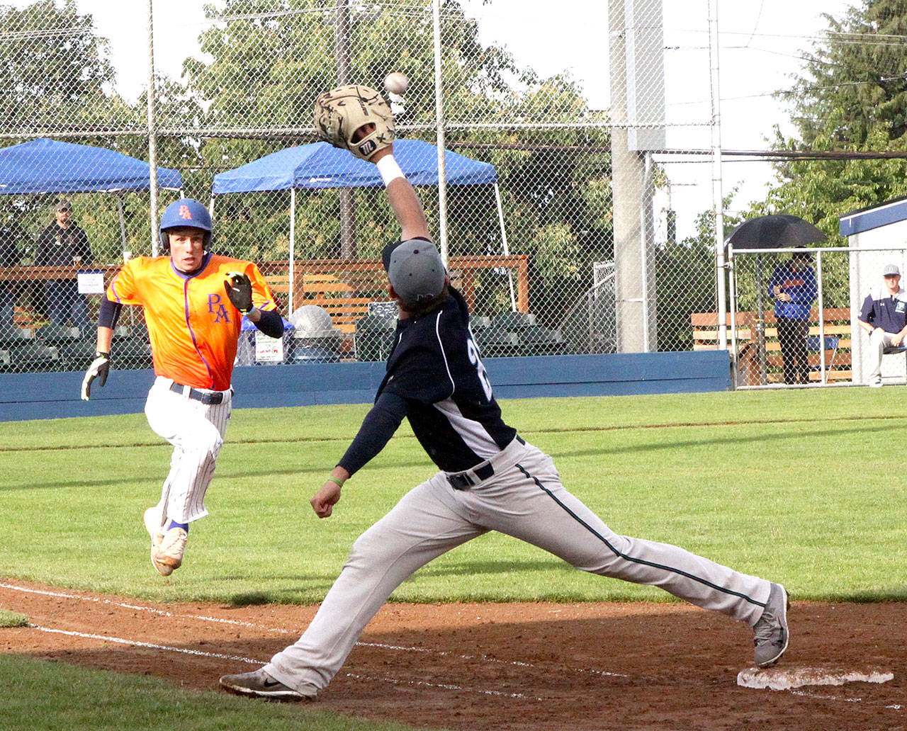 Trevor Rosenberg of the Port Angeles Lefties is out at first base as the Bellingham Bells first baseball Jack Machtolf makes the stretch to punch him out. (Dave Logan/Peninsula Daily News)