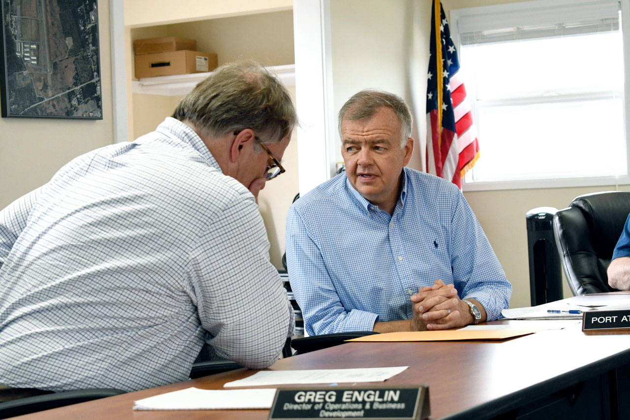 The Port of Port Townsend commissioners named planning director and in-house counsel Eric Toews, right, as interim executive director. Toews is shown talking with Greg Englin, director of operations and port development. (Jeannie McMacken/Peninsula Daily News)