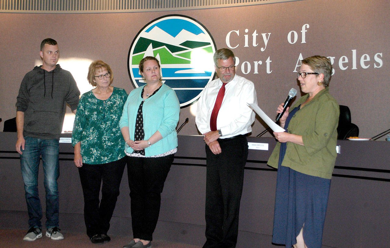 Retired Port Angeles City Manager Dan McKeen, second from right, receives a proclamation from Deputy Mayor Kate Dexter, right, on Tuesday in recognition of his 33 years of service to the city. He is flanked by his son, Joel, his wife, Jan, and daughter, Teresa. Dan McKeen, 62, became Port Angeles Fire Chief in 2000 and City Manager in 2012. His last day working for the city was Wednesday. “I’m looking forward to spending more time with my family, and I’ve been really blessed in my career,” he said. Nathan West, former Port Angeles Community and Economic director and acting city manager, became full-time city manager today. (Rob Ollikainen/Peninsula Daily News)