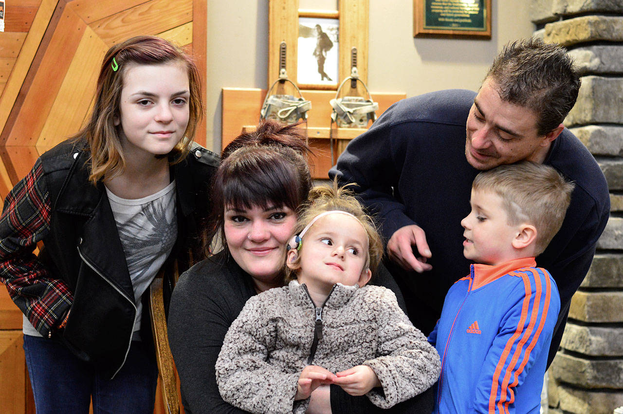 (Diane Urbani de la Paz/for Peninsula Daily News)                                Nina Jones, center, pauses with daughter Sarah, 4, on her lap and Samee, 13, at left, with son Nick, aka Bear, 5, and dad Nick Landvik on her right.