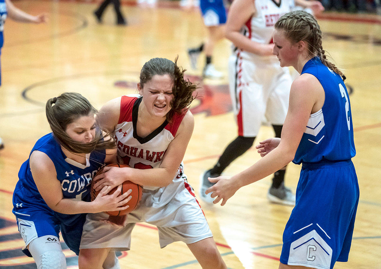 Steve Mullensky/for Peninsula Daily News Chimacum’s Grace Yaley, 1, and Port Townsend’s Aurin Asbell, 12, fight for control of the ball as Chimacum’s Jada Trafton watches during action in a Friday night game in Port Townsend.