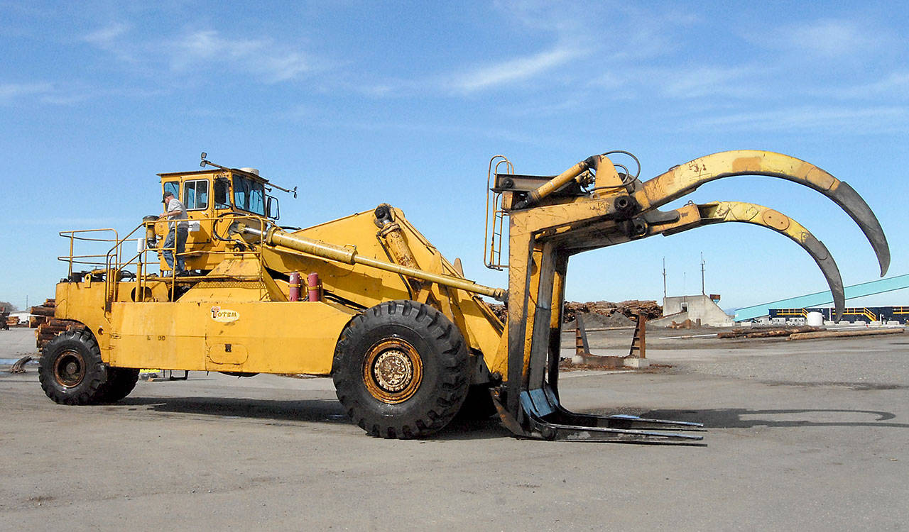 Port of Port Angeles employee Guy Wooldridge leaves the cab of a log stacker that will be replaced with a refurbished machine for the port’s log yard on Marine Drive in Port Angeles. (Keith Thorpe/Peninsula Daily News)