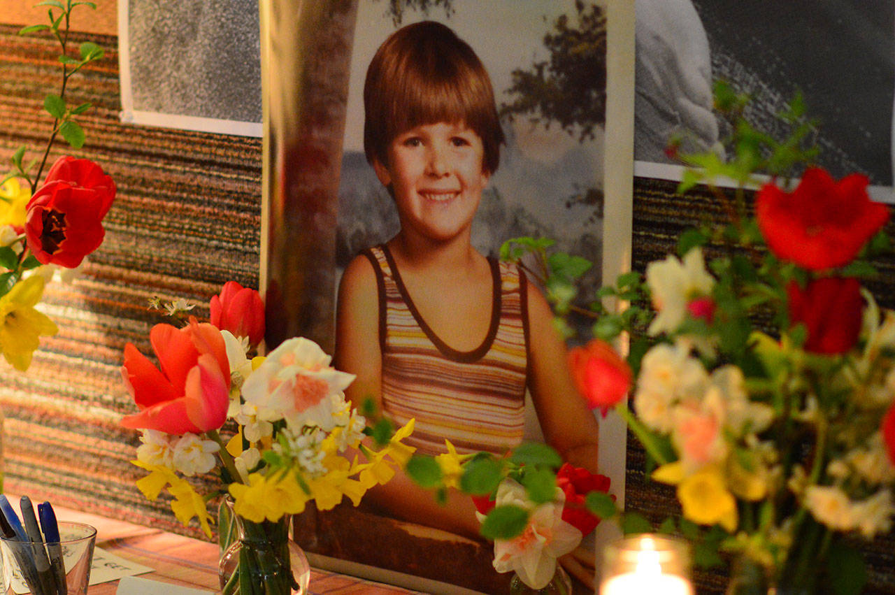 A boyhood photo of Jarrod Paul Bramson stands beside the guest books during a memorial gathering for him Saturday. The event drew hundreds of mourners to the Jefferson County Fairgrounds in Port Townsend. (Diane Urbani de la Paz/for Peninsula Daily News)