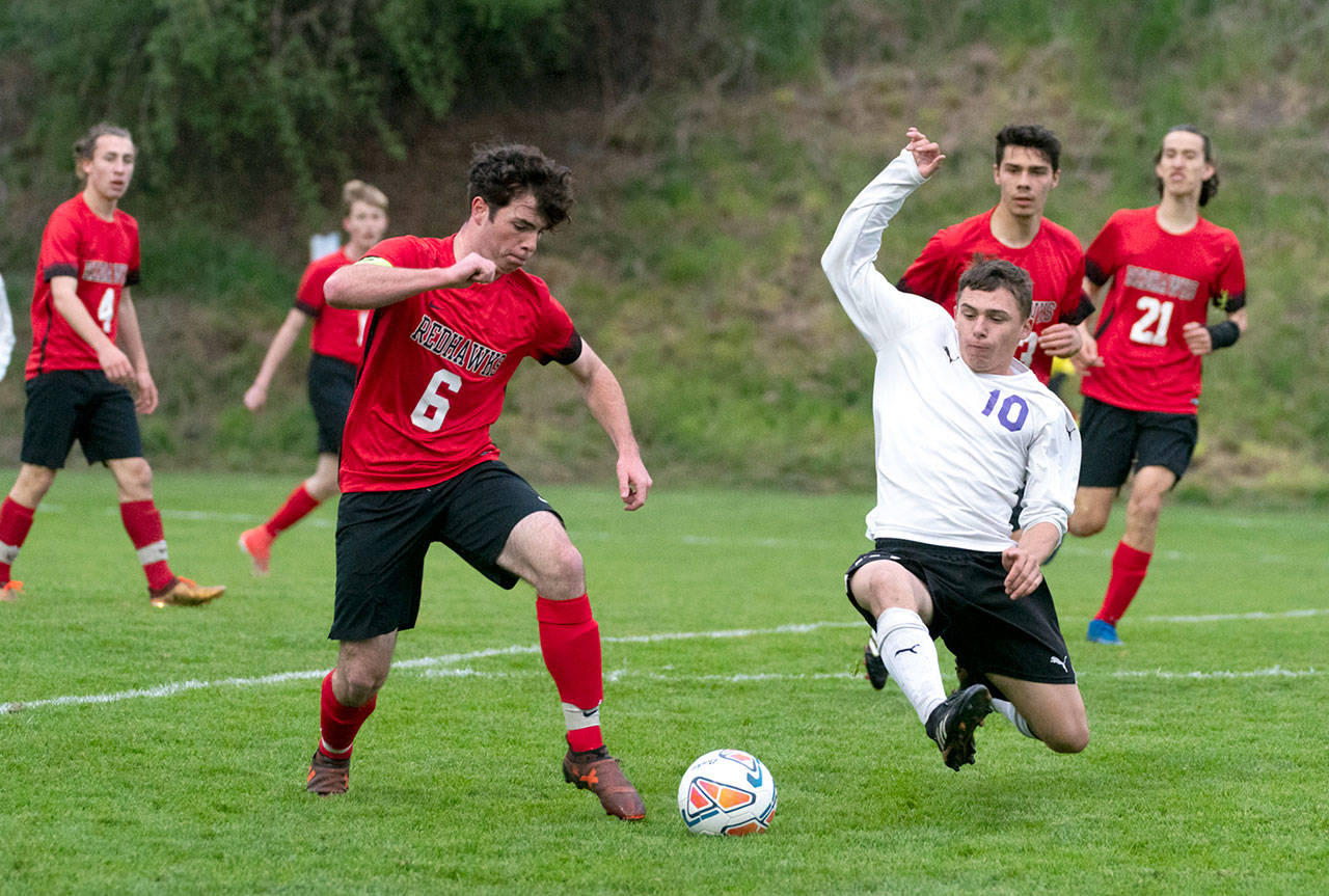 Port Townsend’s Zachary Dempsey, left, and Sequim’s Mathys Tanche vie for control in a game at Memorial Field in Port Townsend on Tuesday. Steve Mullensky/for Peninsula Daily News
