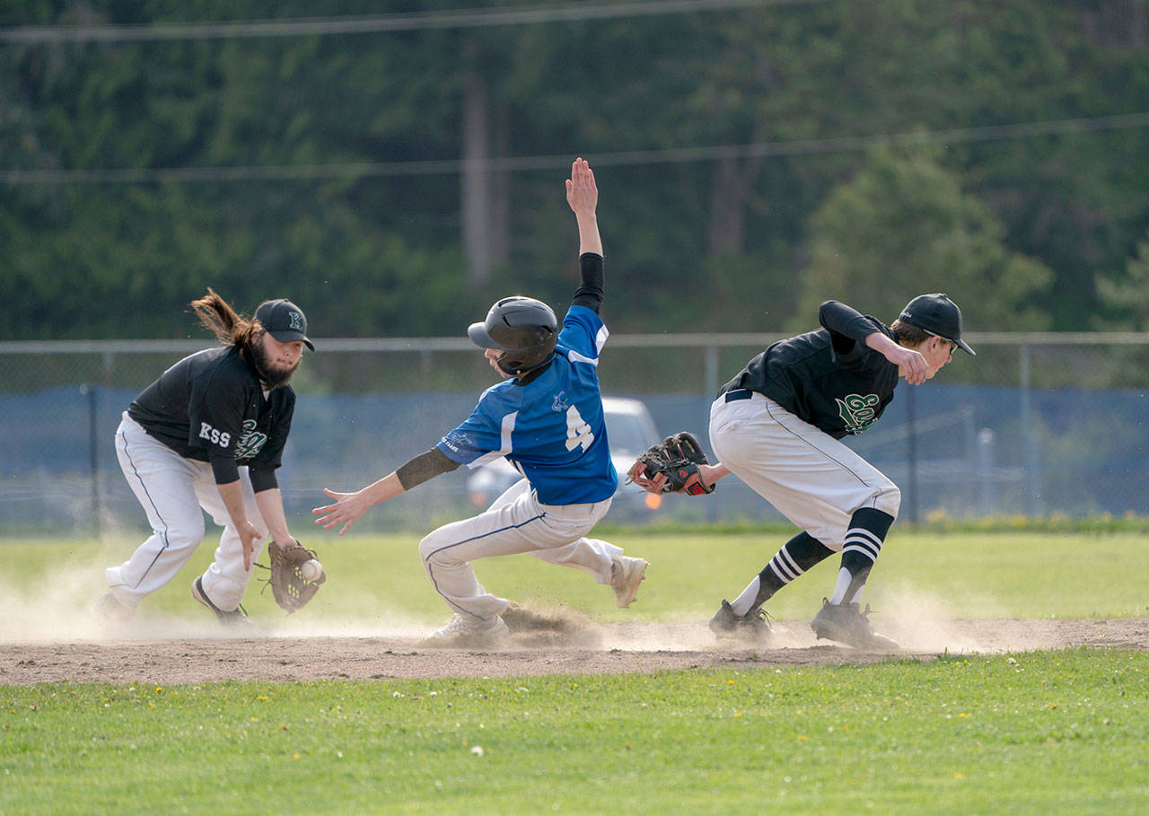 Steve Mullensky/for Peninsula Daily News Chimacum’s Clayton Smith beats the throw to Klahowya’s Logan Prater and slides safely into second on a steal during a game in Chimacum on Friday.