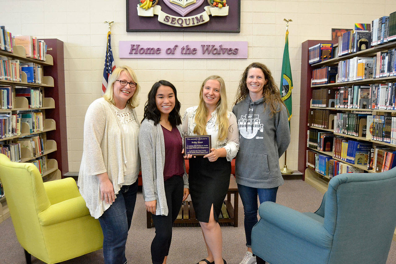 After raising $6,000 for new furnishings under the Robby Streett Legacy Fund, new tables, chairs and coffee tables went into the Sequim High School library. There for the installation are, from left, Josslyn Streett, Lesae Pfeffer, Annabelle Armstrong, and Linsay Rapelje, SHS librarian. (Matthew Nash/Olympic Peninsula News Group)