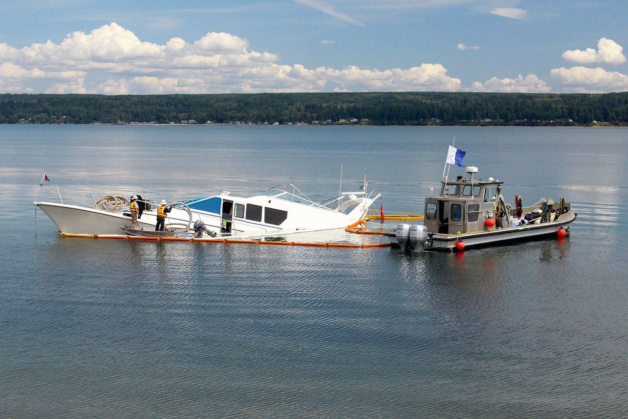 Global Diving and Salvage on Wednesday works to get the 65-foot yacht Silver Lining floating after it struck an unknown object and partially sank Tuesday night near the Hood Canal Bridge. (Zach Jablonski/Peninsula Daily News)