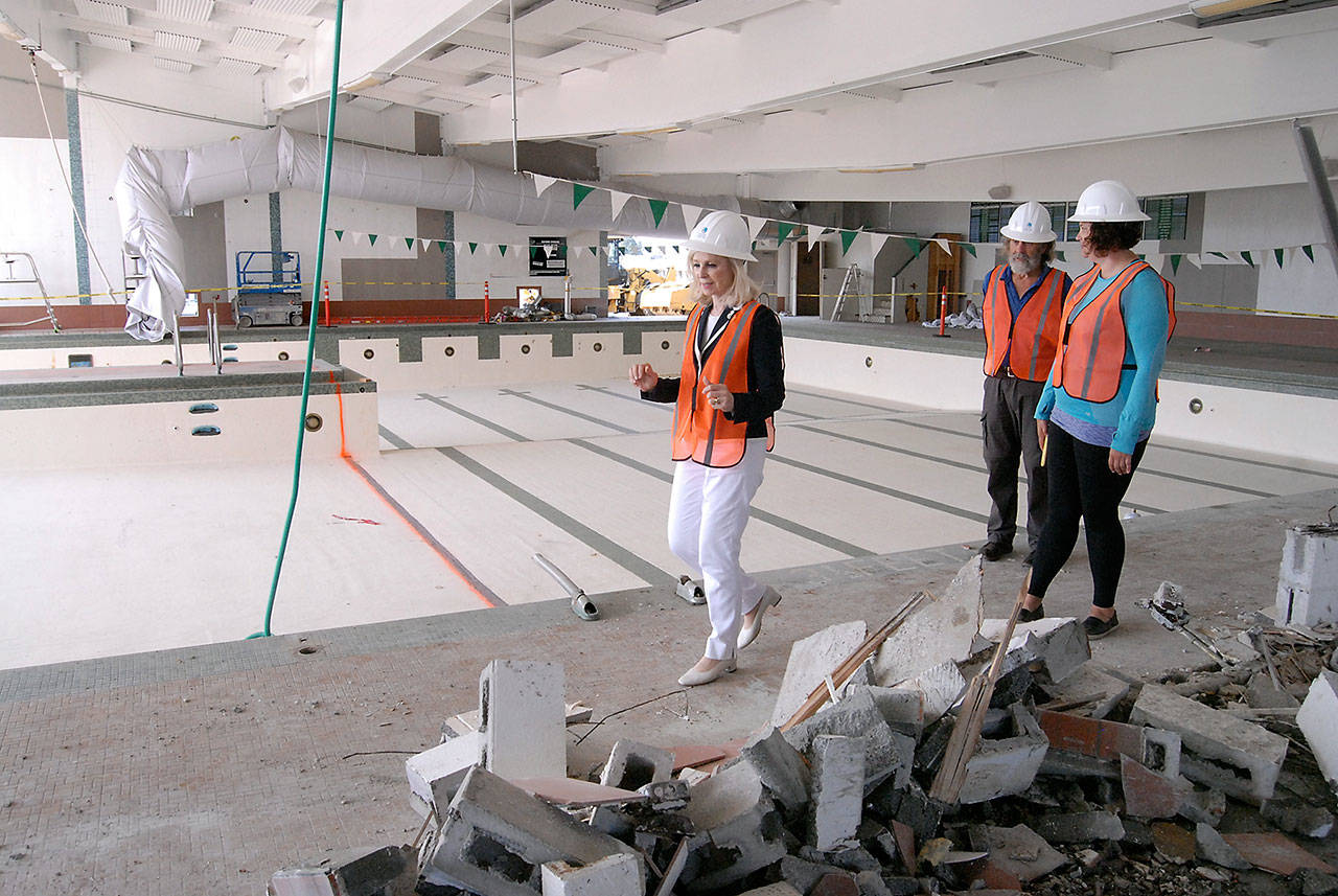 Port Angeles City Council member Cherie Kidd, who is board president of the William Shore Memorial Pool District, left, and Greg Shield, president of the pool’s advisory committee, center, are led by Project Manager Jessica Compton, right, on a tour of the partially-razed pool building Friday. (Keith Thorpe/Peninsula Daily News)