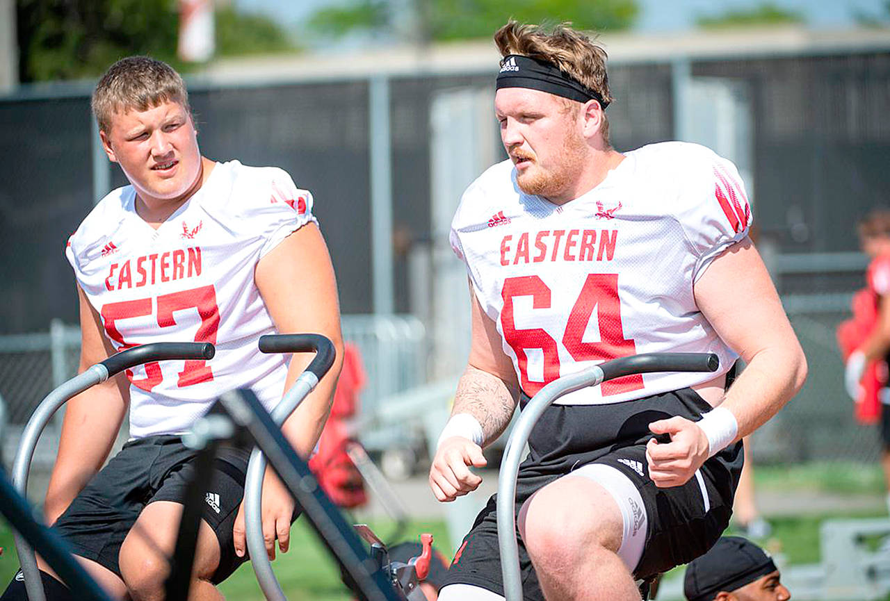 McClatchy News Service Eastern Washington offensive linemen Luke Dahlgren, left of Forks, and Chris Schlichting pedal stationary bikes during a recent practice.