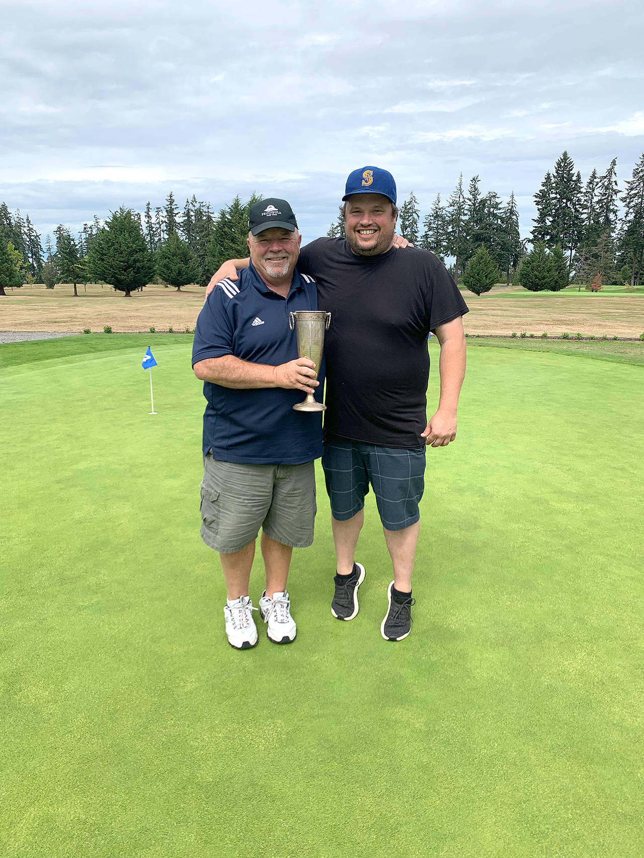 Peninsula Golf Club’s Paul Reed, left, teamed with his son Todd to win the club’s annual Member-Guest Tournament. The Reed’s shot a gross 133 to beat Jade Tisdale and Curtis Rose and Jeremy Copeland and Sid Krump by seven strokes.                                Photo by: Peninsula Golf Club