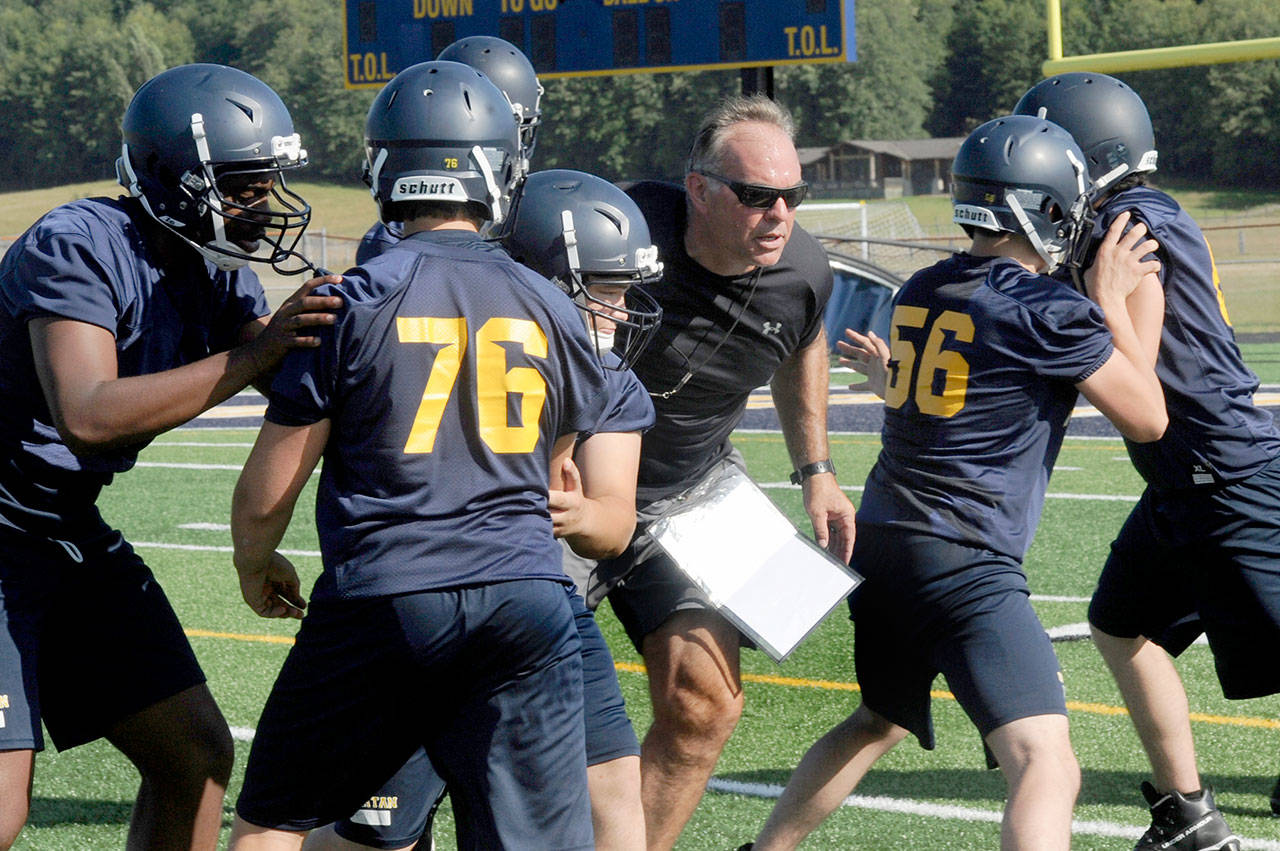 Lonnie Archibald/for Peninsula Daily News New Forks head football coach Trevor Highfield leads players through a preseason practice.