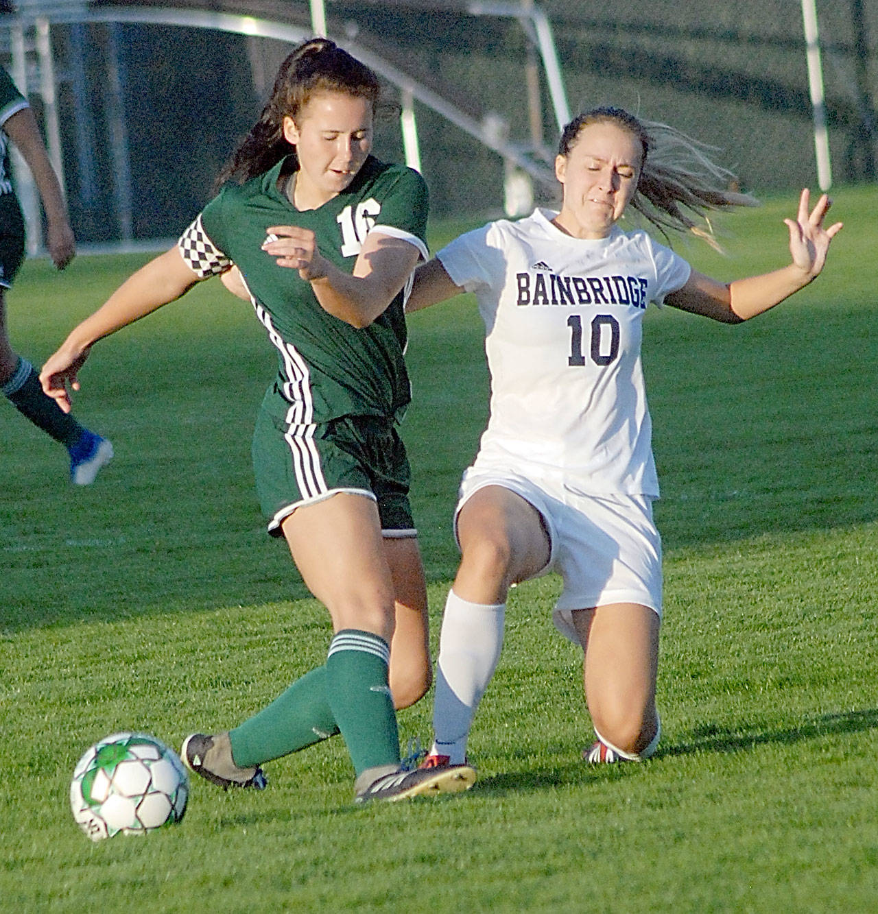 <strong>Keith Thorpe</strong>/Peninsula Daily News Port Angeles’ Delaney Wenzl, left, fends off the defensive efforts of Bainbridge’s Eden Hagen at Civic Field on Tuesday.