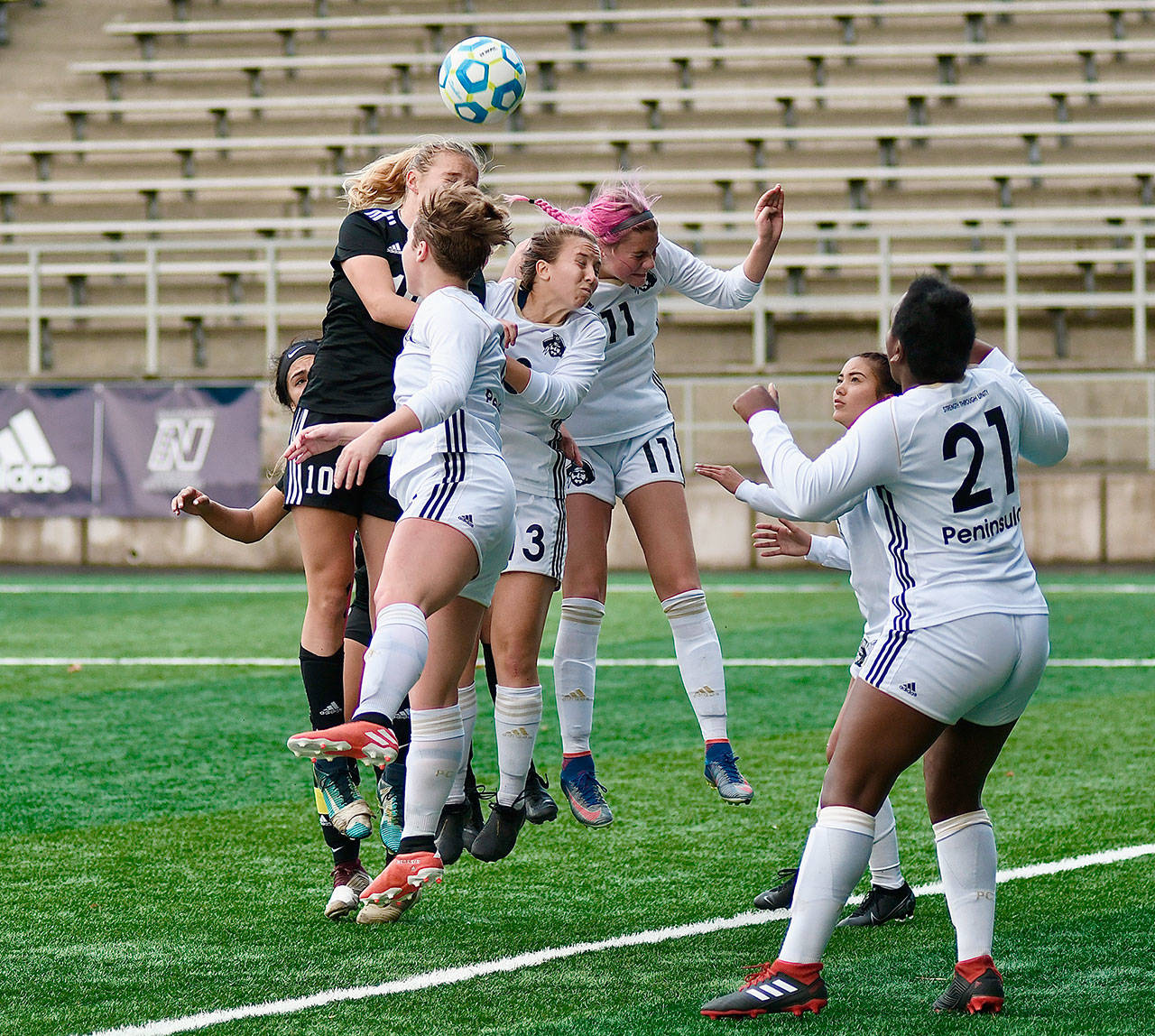 From left, Peninsula Colleges Adeline Becker, Grace Hipke and Alyssa Konarek go up for a header against Tacoma while Tommylia Dunbar (21) stands ready. (Photo courtesy of Peninsula College)