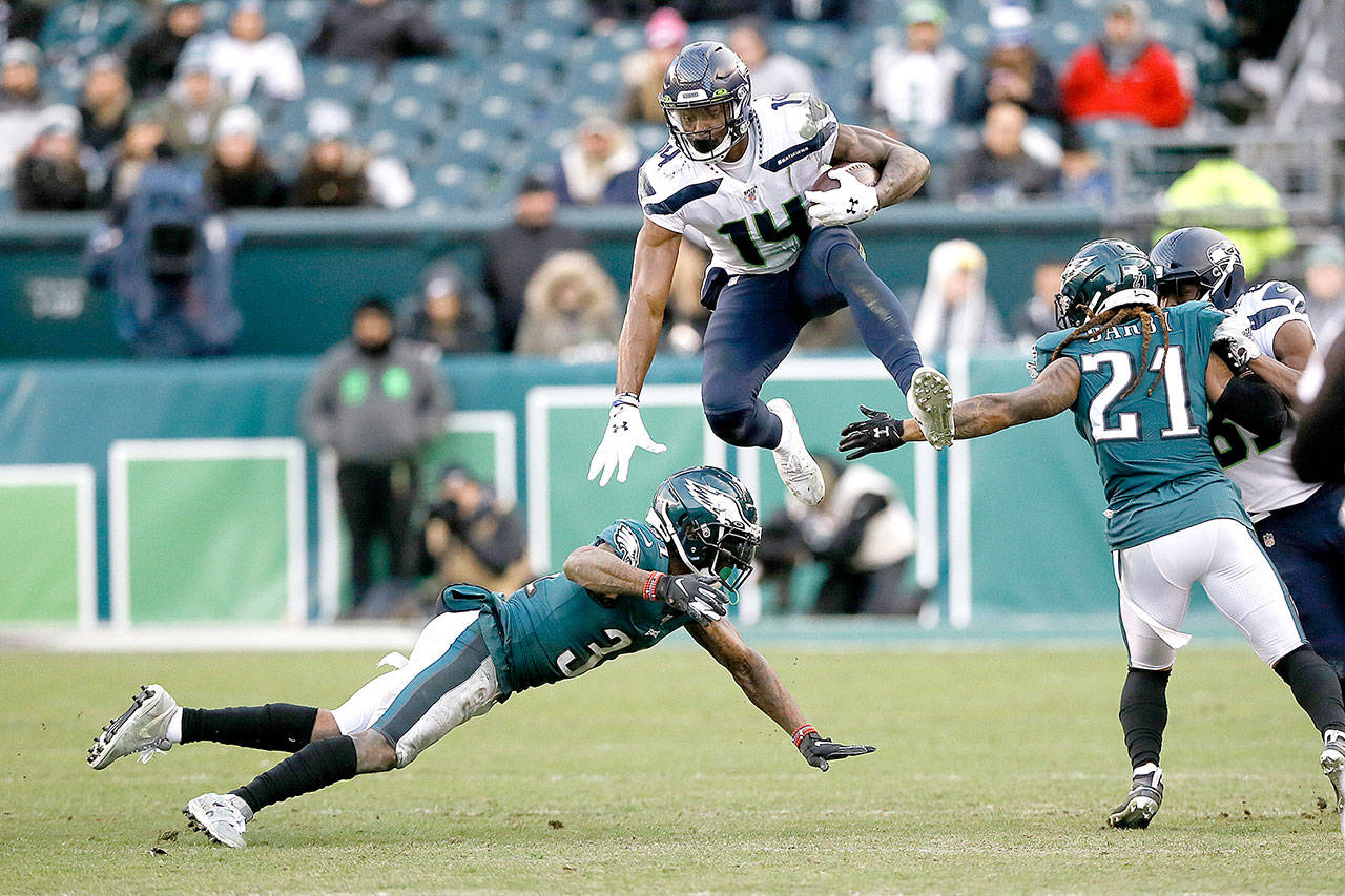 Seattle Seahawks’ DK Metcalf (14) leaps past Philadelphia Eagles’ Jalen Mills (31) and Ronald Darby (21) during the second half of an NFL football game Sunday, Nov. 24, 2019, in Philadelphia. (AP Photo/Michael Perez)
