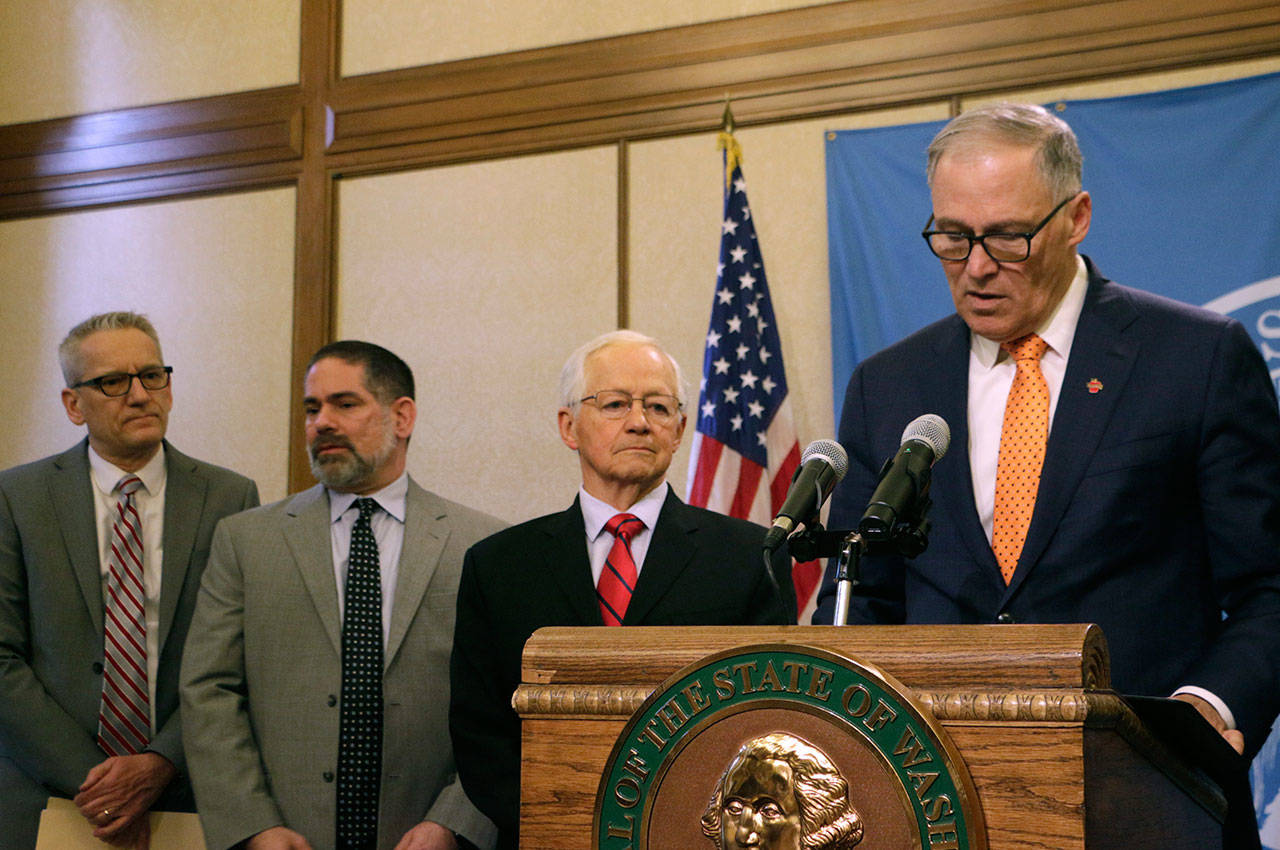 From right to left, Gov. Jay Inslee, Insurance Commissioner Mike Kreidler, Director of the Department of Labor & Industries Joel Sacks and Health Secretary John Wiesman meet with the media to discuss the latest update on coronavirus in the state Thursday, March 5, 2020, in Olympia. (Rachel La Corte/The Associated Press)