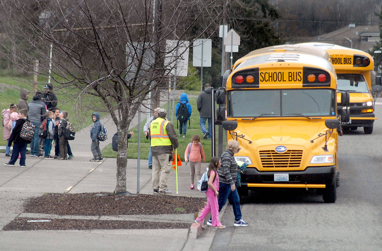 Children board buses at the end of the school day on Friday at Jefferson School in Port Angeles. The students will be on a six-week break beginning Tuesday following a decision made by Gov. Jay Inslee. (Keith Thorpe/Peninsula Daily News)